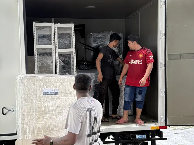 Crew loading furniture panels into the lorry