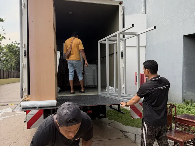 Crew loading items at a building entrance